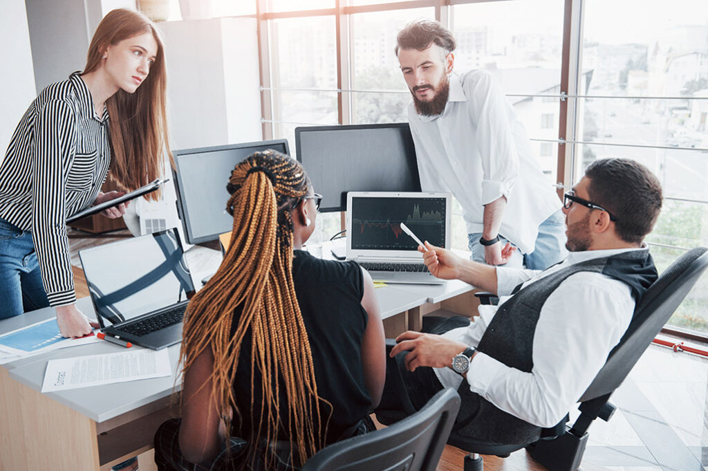 young employees sitting in the office at the table