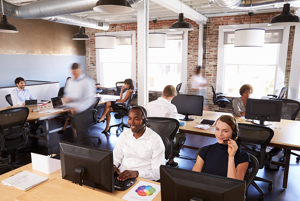 IT support team with headsets on in office