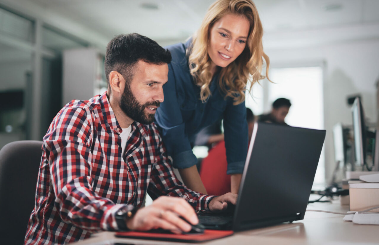 The Need for an IT Compliance Plan 2 IT team building an IT compliance plan together at a computer