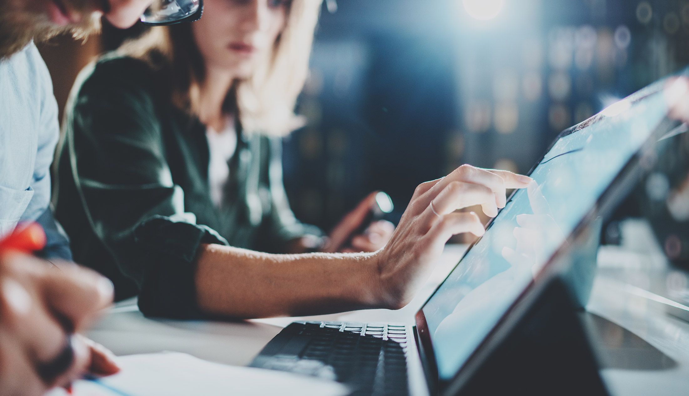 IT workers collaborating at a desk