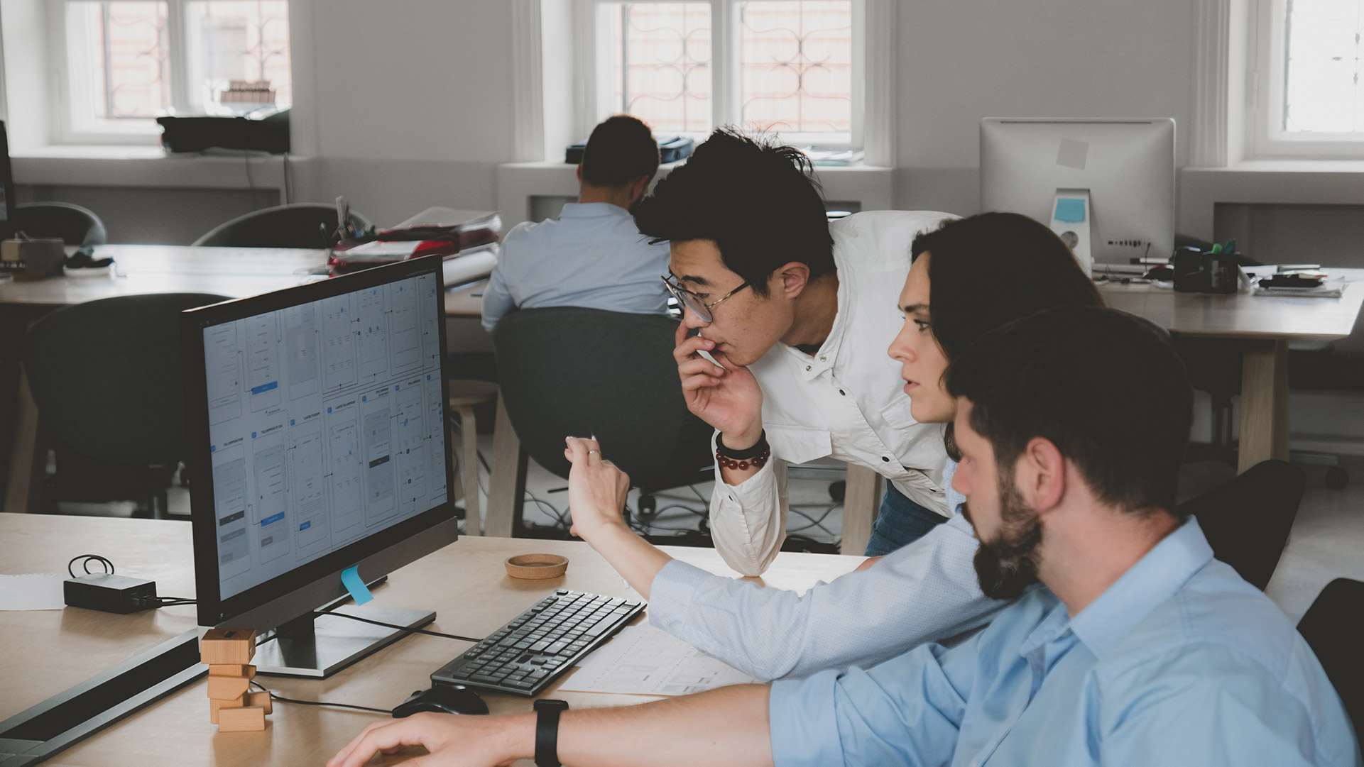 IT team in New Jersey collaborating on a project at a desk