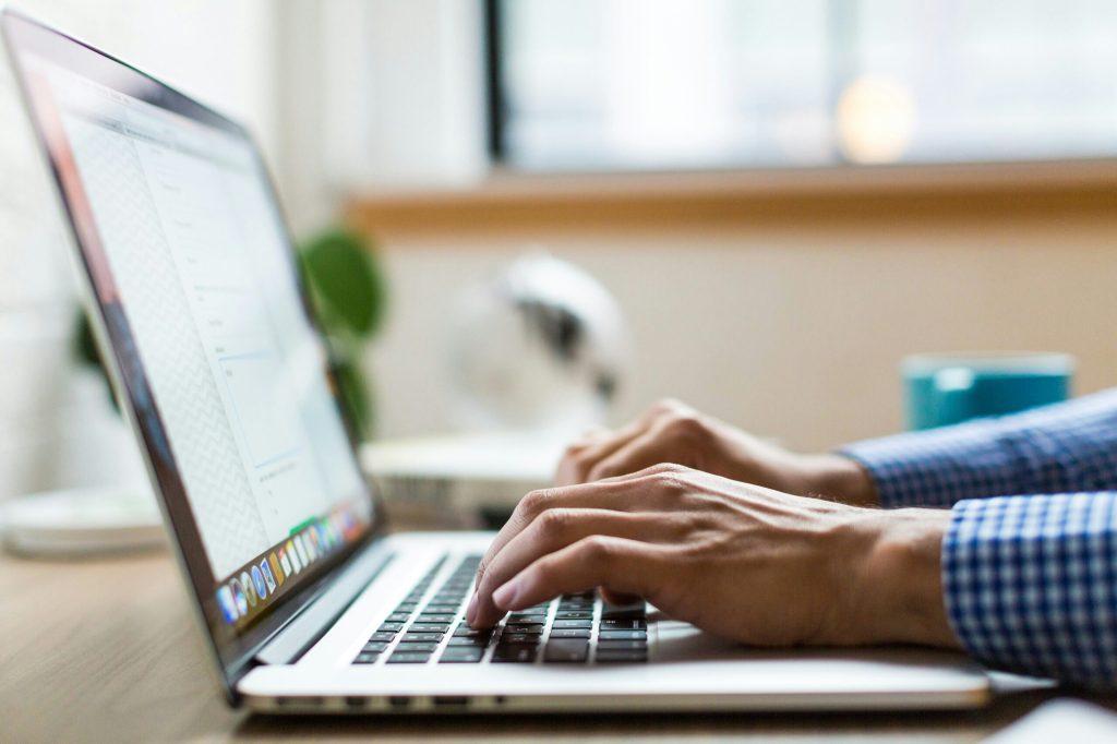 Is Your Business Losing Money Because Employees Can't Use Tech? 1 person typing on silver Macbook