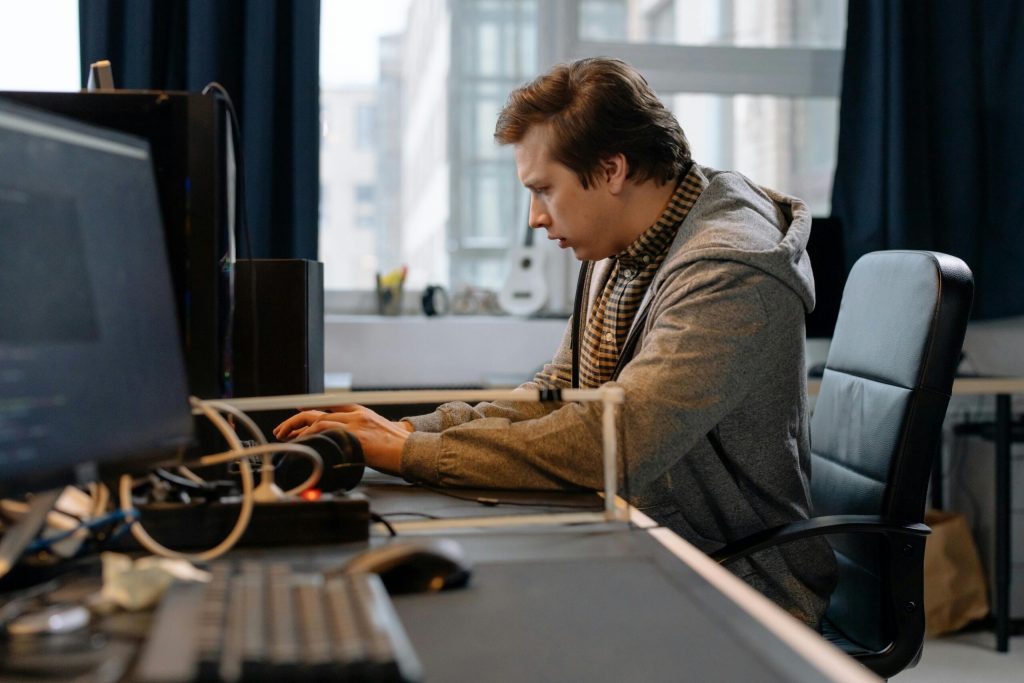 5 Microsoft 365 Tenant Settings Worth Checking 1 Free A concentrated professional working at a computer in a modern office setting. Stock Photo