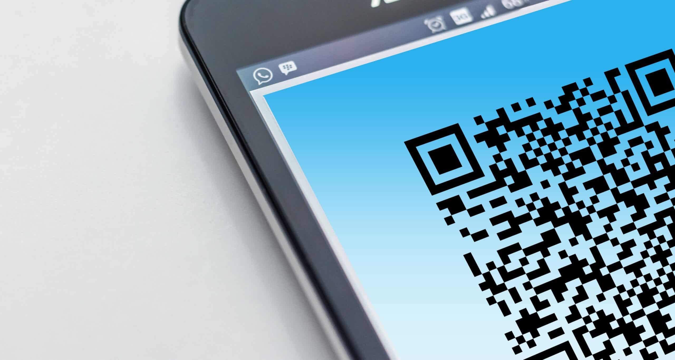 QR Code Scams: What They Are and How to Protect Your Business 2 QR code scams shown as a QR code on a smartphone screen used in a phishing attack