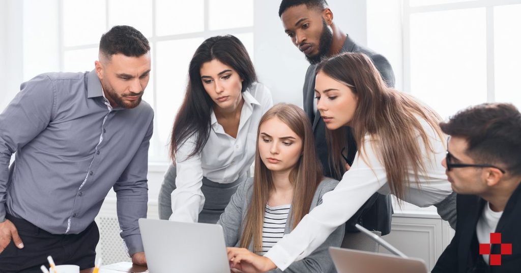When to Replace Small Business Computers: 5 Signs and the 50% Rule 4 Small business team reviewing signs their office computer needs replacement